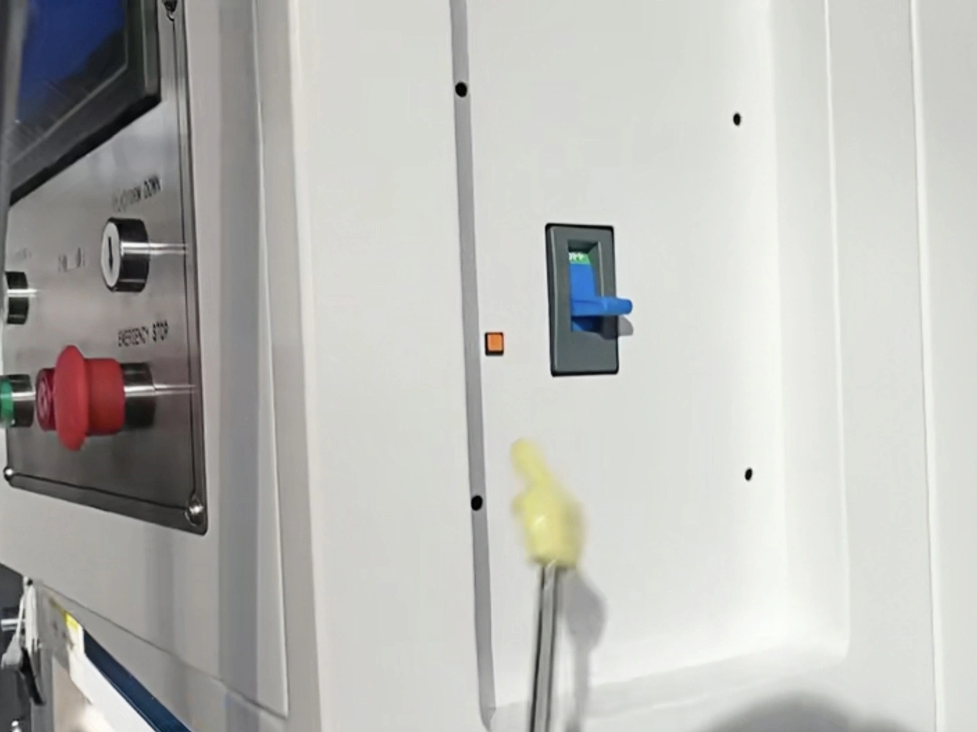 Equipment control enclosure with switches and a blue door handle