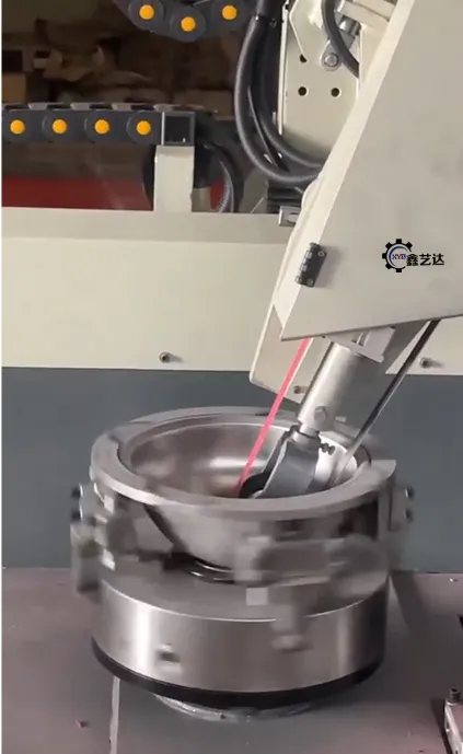Detail of a polishing head working inside a metal vessel held on a rotary fixture