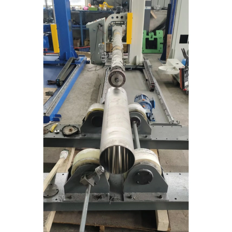 Stainless steel tube on roller supports with a polishing tool aligned to the tube opening
