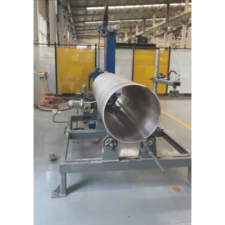 Large cylindrical workpiece on roller supports with an internal polishing tool visible at the open end