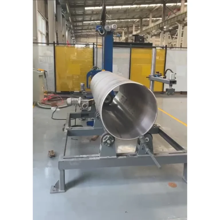 Large cylindrical workpiece on roller supports with an internal polishing tool visible at the open end
