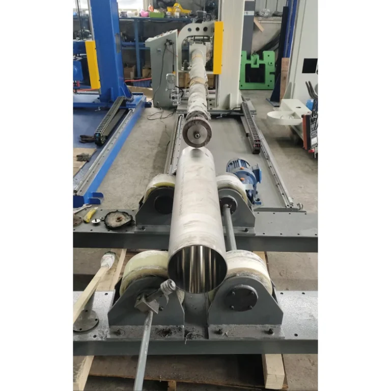 Stainless steel tube on roller supports with a polishing tool aligned to the tube opening